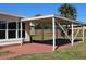 Covered patio features a painted concrete surface and overlooks the backyard at 21456 Holdern Ave, Port Charlotte, FL 33952