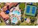 Stunning aerial view of resort-style pools and tennis courts surrounded by lush landscaping at 2478 Brassica Dr, North Port, FL 34289