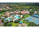 Stunning aerial view showcases the community's resort-style pool, tennis courts, and lush landscaping at 2478 Brassica Dr, North Port, FL 34289