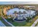 Aerial view of Del Webb Cypress Falls entrance, lake, and surrounding neighborhood at 2478 Brassica Dr, North Port, FL 34289