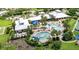 Aerial view of the community amenities featuring a pool, clubhouse, and tennis courts at 2478 Brassica Dr, North Port, FL 34289