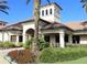 Beautiful community clubhouse featuring tropical landscaping, attractive architecture, and a welcoming entrance at 2478 Brassica Dr, North Port, FL 34289