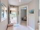 Inviting foyer with tiled floors, neutral paint, and a view of the front porch and a seating room at 2478 Brassica Dr, North Port, FL 34289