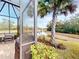 Screened in patio overlooking a peaceful pond, with outdoor seating area and a barbecue grill at 2478 Brassica Dr, North Port, FL 34289