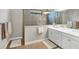 Bathroom featuring double sinks, a shower, and tiled floors at 26798 Weiskopf Dr, Englewood, FL 34223