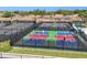 People playing on the community pickleball courts with green, red, and blue surfaces at 26798 Weiskopf Dr, Englewood, FL 34223