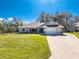 Charming single-story home featuring a well-maintained lawn and attached two-car garage at 27385 Neaptide Dr, Punta Gorda, FL 33983