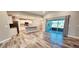 Open concept living space with wood-look floors and a view of the modern kitchen at 342 Sweetwater Dr, Rotonda West, FL 33947