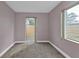 Relaxing bedroom with soft carpet, natural light, and outdoor access at 520 Sharon Cir, Port Charlotte, FL 33952