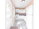 Compact kitchen featuring tile floors, white cabinets, and modern appliances at 520 Sharon Cir, Port Charlotte, FL 33952