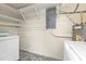 Utility room with washer, dryer, water heater, shelving, and electrical panel at 520 Sharon Cir, Port Charlotte, FL 33952