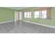 Bright living room with tile floors, two large windows, and neutral walls at 520 Sharon Cir, Port Charlotte, FL 33952