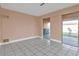 Neutral room with tile flooring and sliding doors to outside patio at 520 Sharon Cir, Port Charlotte, FL 33952