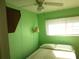 Bright bedroom with green walls, a ceiling fan, and a comfortable single bed at 5233 Palena Blvd, North Port, FL 34287