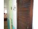 Hallway with a louvred closet door and glimpses of the interior spaces at 5233 Palena Blvd, North Port, FL 34287