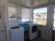 Bright laundry room featuring washer, dryer, laundry basket and shelving at 5233 Palena Blvd, North Port, FL 34287
