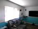 Living room featuring a comfortable sofa, large window, and modern television at 5233 Palena Blvd, North Port, FL 34287