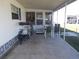 Covered patio space with seating and a bicycle, perfect for relaxing outdoors at 5233 Palena Blvd, North Port, FL 34287