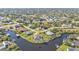 Aerial view of the property with a waterfront location and private dock at 9428 Bandera Ln, Port Charlotte, FL 33981