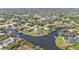 Expansive aerial view of homes and canals in a waterfront community surrounded by lush greenery at 9428 Bandera Ln, Port Charlotte, FL 33981