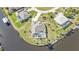 Aerial of a waterfront property with a private pool and dock, showcasing a desirable outdoor living space at 9428 Bandera Ln, Port Charlotte, FL 33981