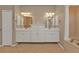 Bright bathroom features dual sinks, decorative mirrors, a soaking tub and shower; offering luxury and convenience at 9428 Bandera Ln, Port Charlotte, FL 33981