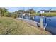 A concrete dock in the backyard with access to the calm lake water at 9428 Bandera Ln, Port Charlotte, FL 33981