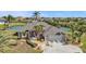 Beautiful single-story waterfront home featuring mature landscaping and an attached two-car garage at 9428 Bandera Ln, Port Charlotte, FL 33981