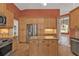 Beautiful kitchen boasts stainless steel appliances, granite countertops, and a functional center island at 9428 Bandera Ln, Port Charlotte, FL 33981