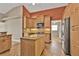 Modern kitchen with stainless steel refrigerator and island with granite countertops at 9428 Bandera Ln, Port Charlotte, FL 33981