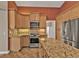 Charming kitchen with light cabinetry, granite countertops, and stainless-steel appliances for modern cooking at 9428 Bandera Ln, Port Charlotte, FL 33981