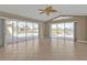 Bright living room with tile flooring and sliding glass doors overlooking pool and water views at 9428 Bandera Ln, Port Charlotte, FL 33981