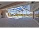 Inviting screened-in pool area offers a relaxing retreat overlooking a tranquil waterway and lush palm trees, perfect for outdoor enjoyment at 9428 Bandera Ln, Port Charlotte, FL 33981