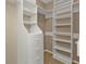 Spacious walk-in closet with custom shelving and storage solutions, offering ample space for organization and personal items at 9428 Bandera Ln, Port Charlotte, FL 33981