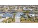 Aerial view of a beautiful home with a two-car garage, and tropical landscaping at 960 Messina Dr, Punta Gorda, FL 33950