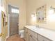 Well-lit bathroom featuring decorative mirror, vanity with storage, and a glass-enclosed shower at 960 Messina Dr, Punta Gorda, FL 33950