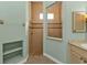 Modern bathroom featuring a tiled walk-in shower with glass enclosure, floating vanity and open shelving unit at 960 Messina Dr, Punta Gorda, FL 33950
