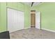 Spacious bedroom featuring tile flooring and a large closet with white doors at 960 Messina Dr, Punta Gorda, FL 33950