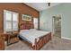 Bedroom featuring an elaborate wooden bed frame, decorative wall art, shuttered windows, and an ensuite bathroom at 960 Messina Dr, Punta Gorda, FL 33950