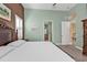 Bedroom featuring an elaborate wooden bed frame, decorative wall art, and access to both a closet and bathroom at 960 Messina Dr, Punta Gorda, FL 33950