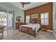 Bedroom featuring an elaborate wooden bed frame, outdoor access, decorative wall art and shuttered windows at 960 Messina Dr, Punta Gorda, FL 33950