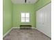 Bright bedroom with a ceiling fan, tile flooring, window and bench, and large closet with white doors at 960 Messina Dr, Punta Gorda, FL 33950