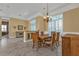 Dining room featuring a wood table, chandelier, and bar area with a built-in cabinet at 960 Messina Dr, Punta Gorda, FL 33950