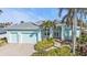 Charming home exterior featuring a two-car garage, landscaping, and a walkway to a covered entrance at 960 Messina Dr, Punta Gorda, FL 33950