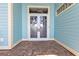 Beautiful etched glass double front door with brick paver landing and light blue siding at 960 Messina Dr, Punta Gorda, FL 33950
