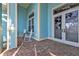 Inviting front porch featuring brick flooring and stylish double-door entry at 960 Messina Dr, Punta Gorda, FL 33950