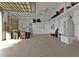 Spacious garage with epoxy flooring, storage cabinets, and high ceilings, offering ample room at 960 Messina Dr, Punta Gorda, FL 33950