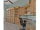 Home office space featuring custom built-in shelving, cabinets, desk area and tile floors at 960 Messina Dr, Punta Gorda, FL 33950