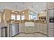 A well-lit kitchen with stainless steel appliances and a farmhouse sink at 960 Messina Dr, Punta Gorda, FL 33950