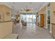 Bright living room with tile flooring, tan walls, and a sliding glass door with water view at 960 Messina Dr, Punta Gorda, FL 33950
